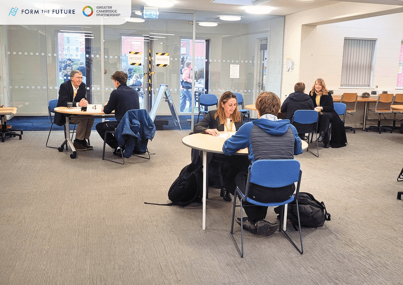 Photo from the mock interview event showing students at tables