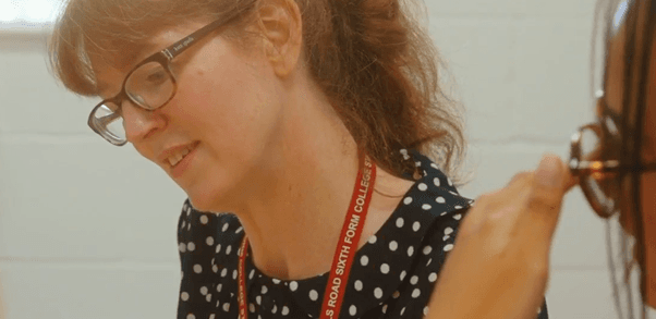 Teacher helping students