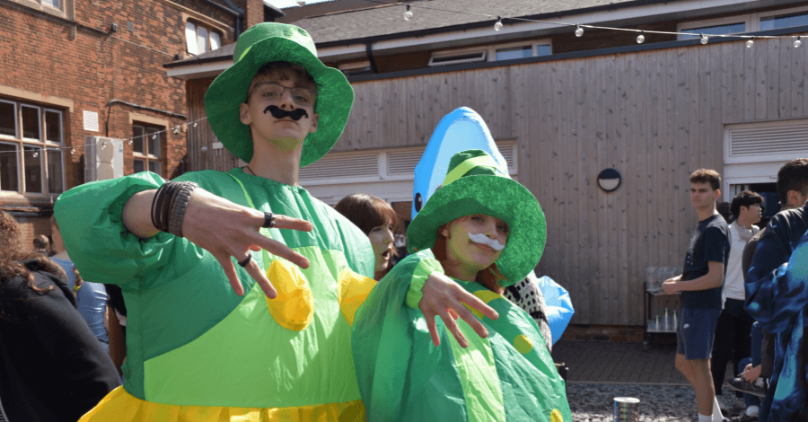 two students dressed up as dinosaurs for HR 4.5 fun run 2025