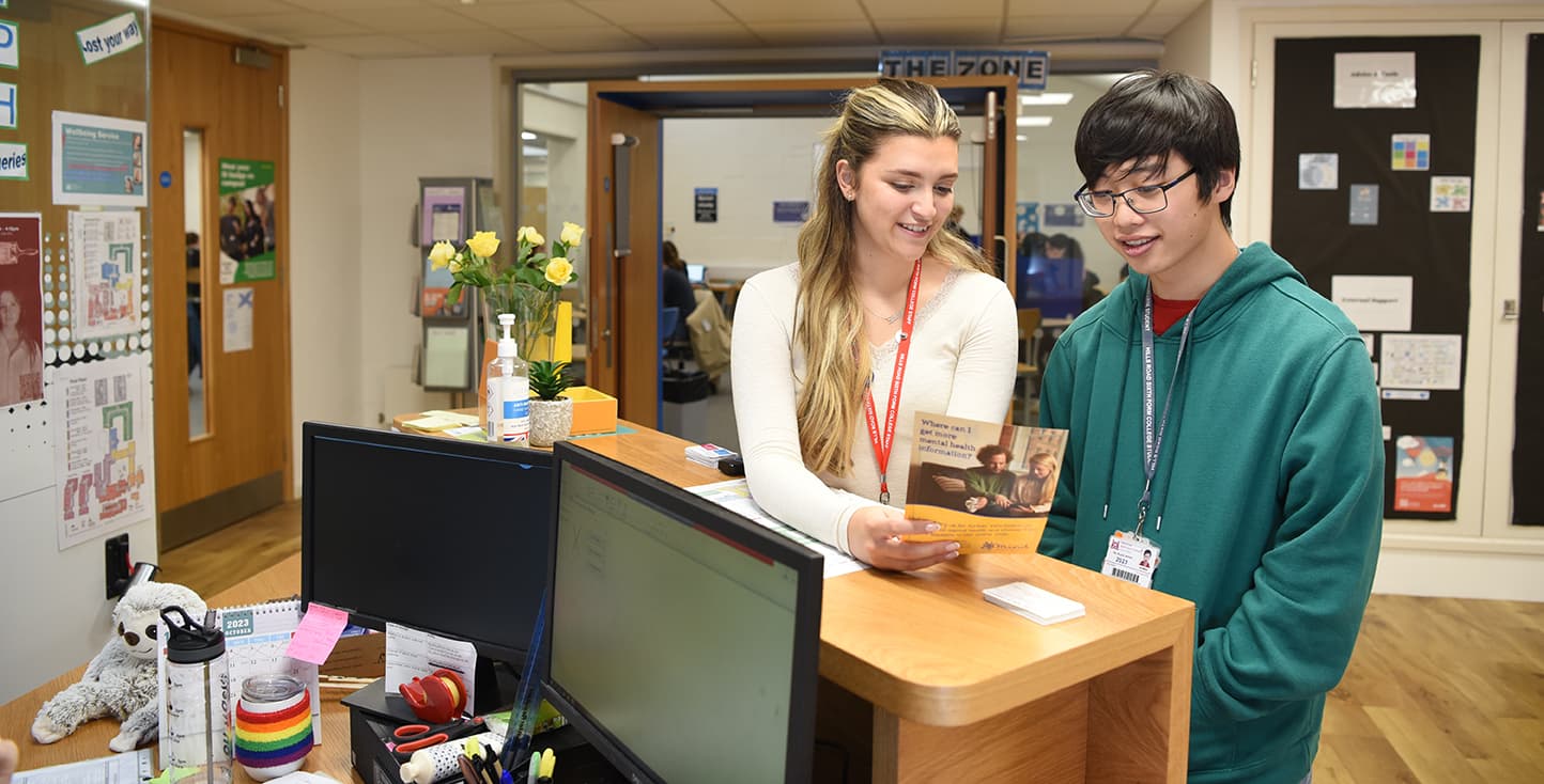 Student talking to member of staff