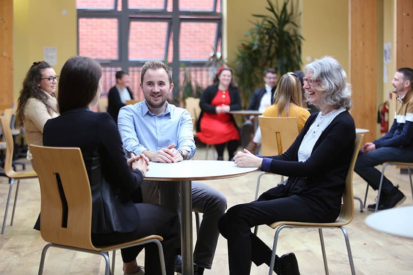 groups of people sitting around tables